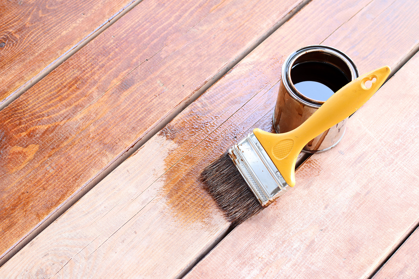 Stain and brush against a pressure-treated lumber